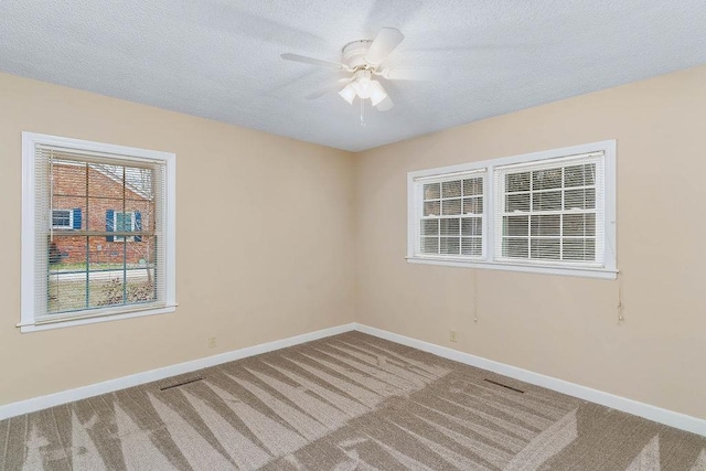 unfurnished room featuring ceiling fan and carpet flooring