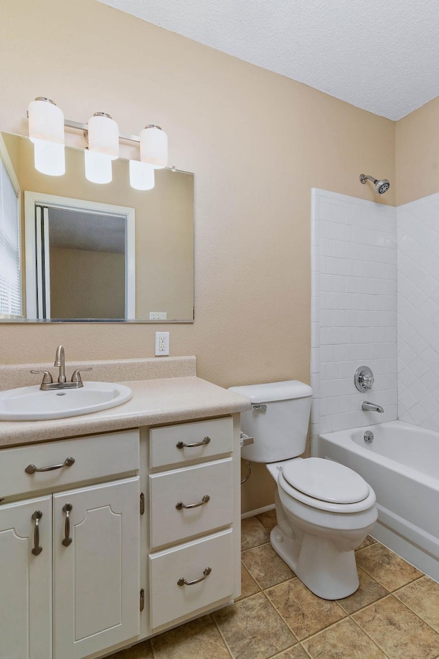 full bathroom featuring tiled shower / bath combo, vanity, and toilet