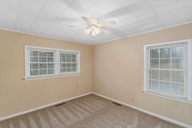 unfurnished room featuring crown molding, carpet flooring, and ceiling fan