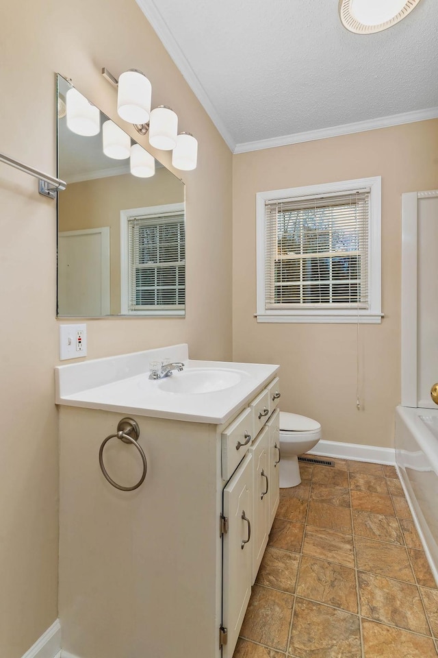 bathroom featuring vanity, ornamental molding, a textured ceiling, and toilet