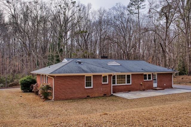 rear view of property featuring a yard and a patio area