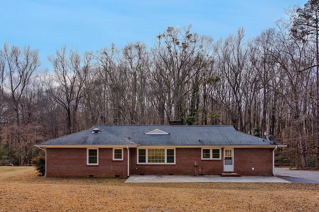 rear view of house with a patio area and a lawn