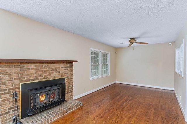 unfurnished living room with hardwood / wood-style flooring, a healthy amount of sunlight, and a textured ceiling