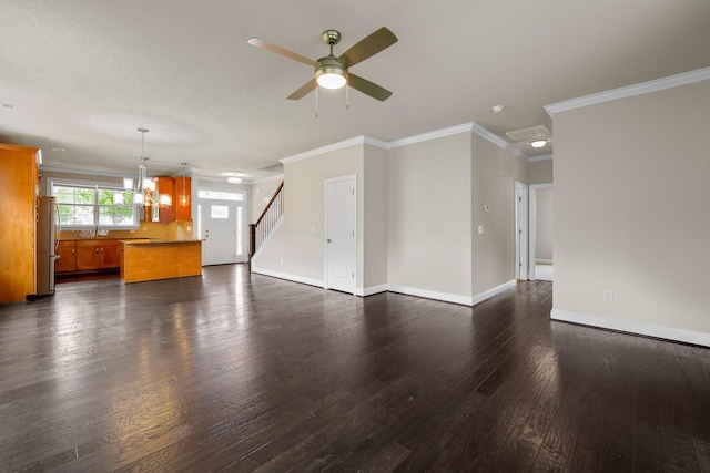 unfurnished living room featuring crown molding, ceiling fan with notable chandelier, and dark hardwood / wood-style floors