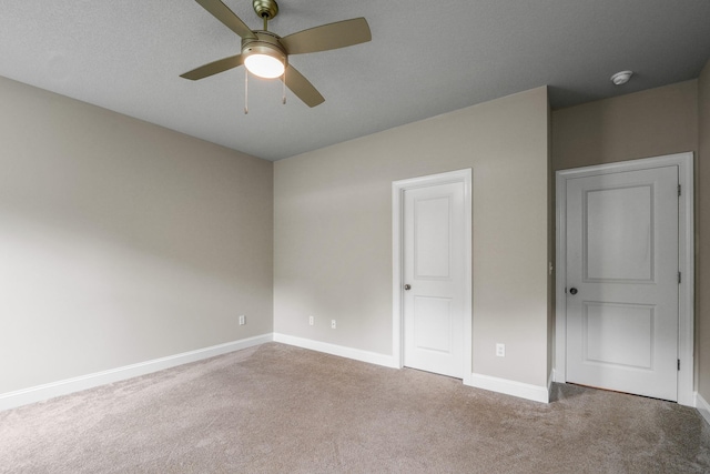 unfurnished bedroom featuring carpet floors and ceiling fan