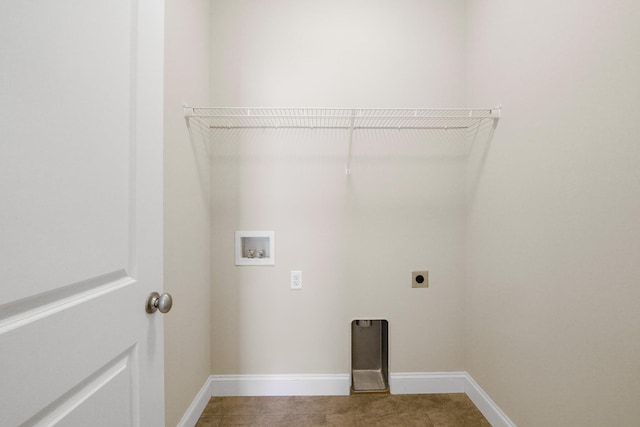 laundry room with electric dryer hookup, hookup for a washing machine, and tile patterned floors