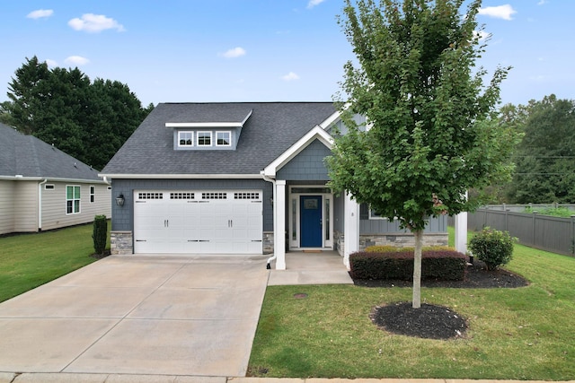 view of front of house with a garage and a front lawn