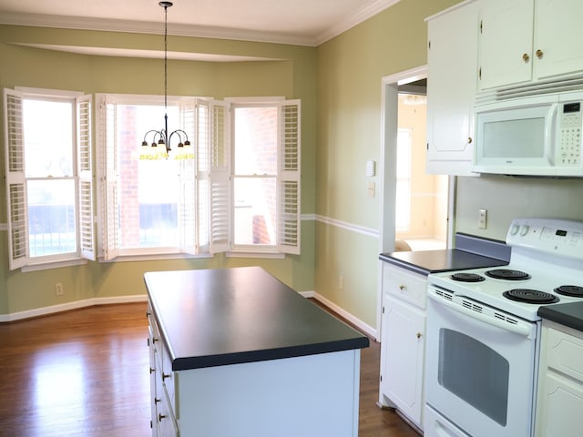 kitchen featuring white appliances, a wealth of natural light, white cabinets, a kitchen island, and decorative light fixtures