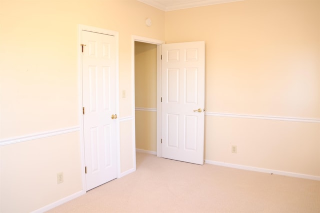 unfurnished bedroom featuring light colored carpet and ornamental molding