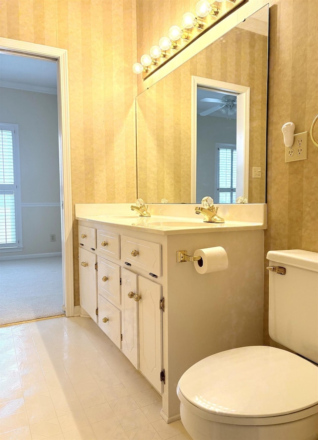 bathroom featuring vanity, crown molding, and toilet