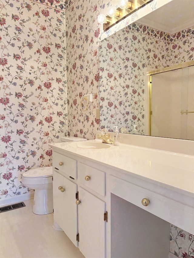 bathroom featuring vanity, crown molding, and toilet