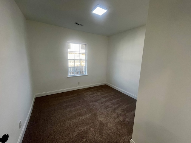 empty room featuring dark carpet