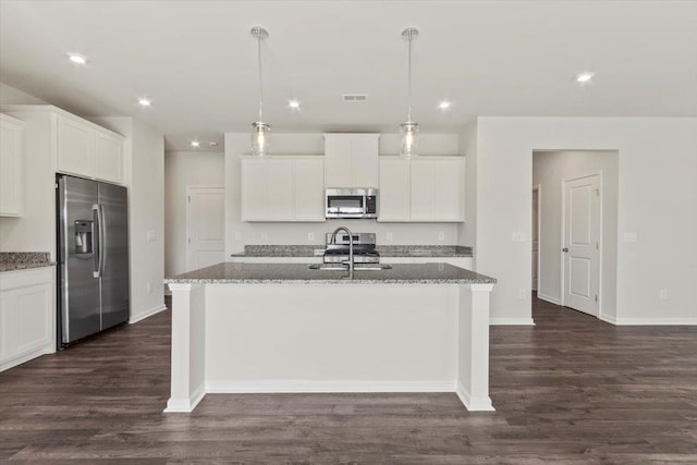 kitchen with a kitchen island with sink, hanging light fixtures, white cabinetry, and stainless steel appliances