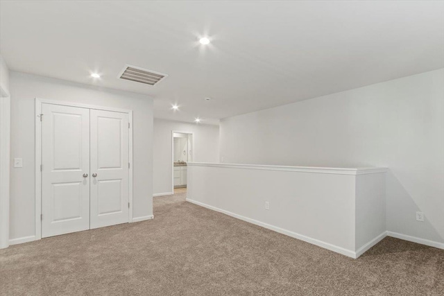 basement featuring light colored carpet