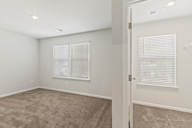 spare room with light colored carpet