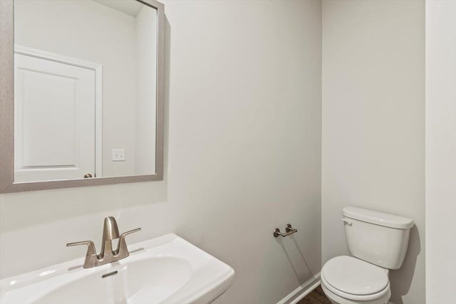 bathroom featuring sink and toilet