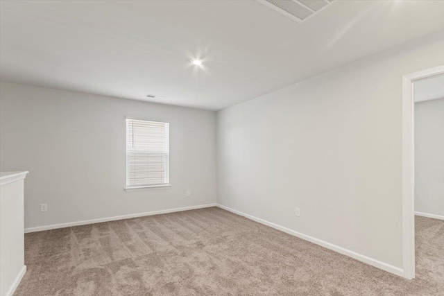 unfurnished room featuring light colored carpet