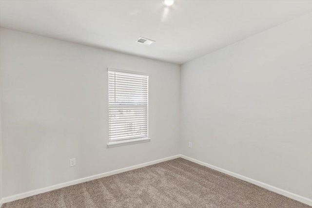 unfurnished room with light colored carpet