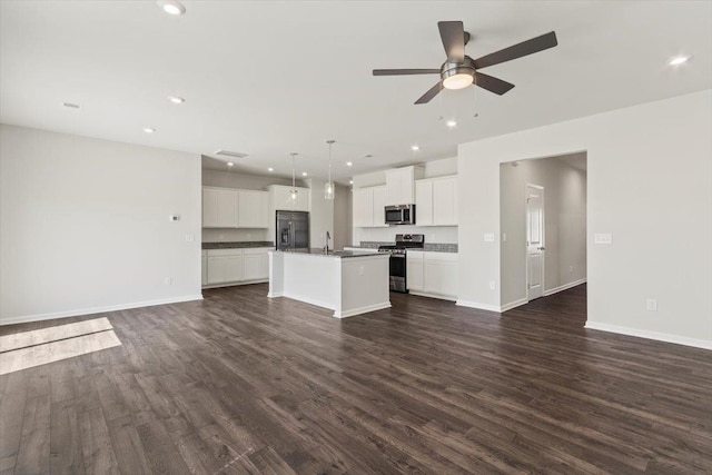 unfurnished living room with sink, dark wood-type flooring, and ceiling fan