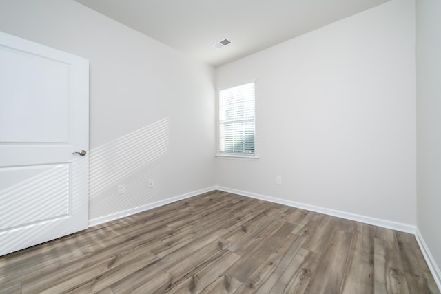 spare room with hardwood / wood-style floors