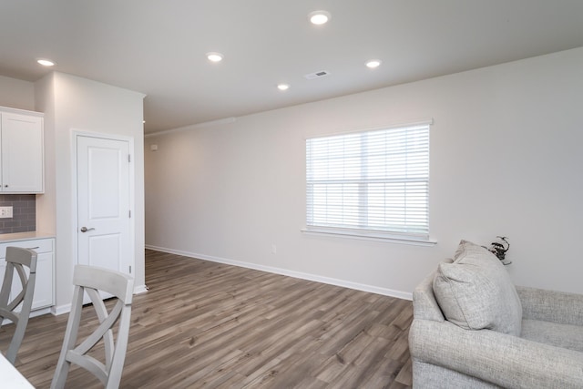 living area with wood-type flooring and a wealth of natural light