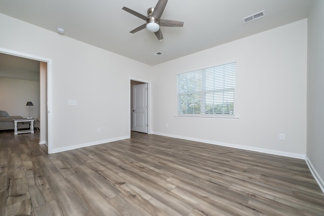 unfurnished bedroom featuring dark wood-type flooring and ceiling fan