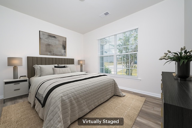 bedroom with hardwood / wood-style floors