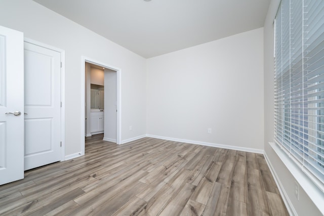 unfurnished room with light wood-type flooring