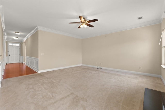 spare room featuring crown molding, light colored carpet, and ceiling fan