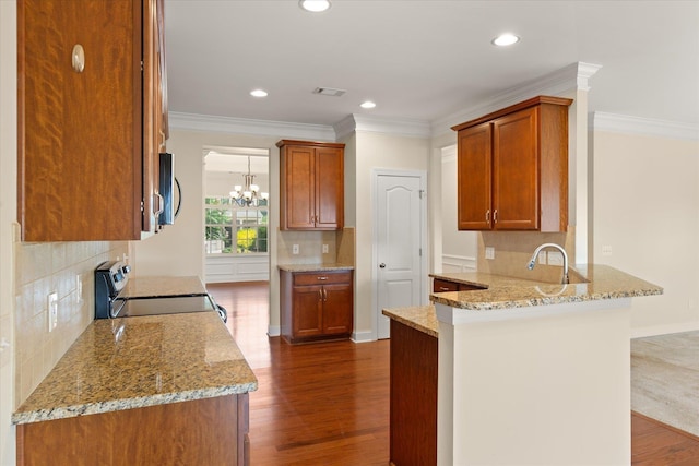 kitchen with electric range oven, backsplash, light stone counters, kitchen peninsula, and crown molding