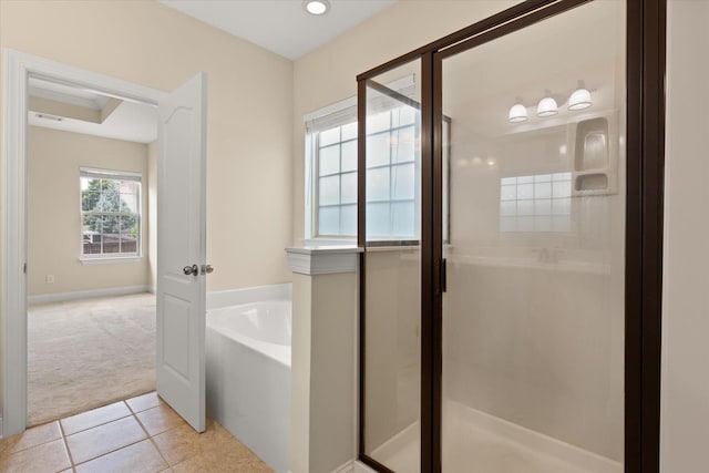 bathroom featuring tile patterned floors and shower with separate bathtub