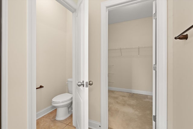 bathroom with tile patterned flooring and toilet