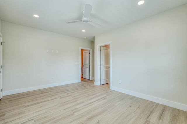 empty room with ceiling fan and light wood-type flooring