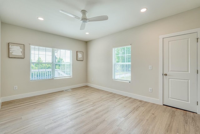 unfurnished room with ceiling fan and light hardwood / wood-style floors