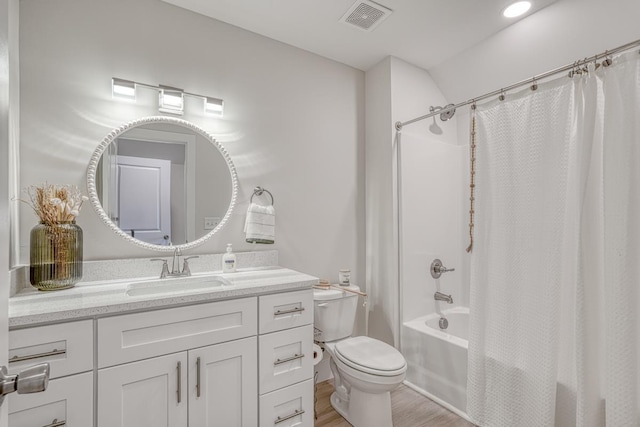 full bathroom with wood-type flooring, toilet, vanity, and shower / bath combo