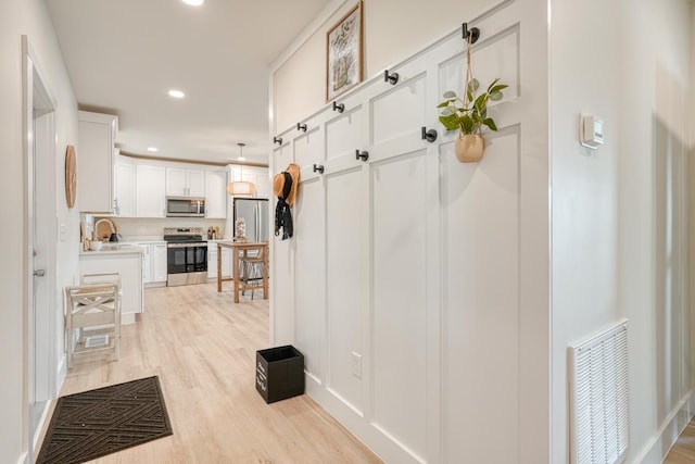 hall featuring light hardwood / wood-style floors