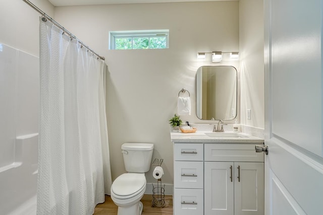 bathroom featuring vanity, hardwood / wood-style flooring, a shower with curtain, and toilet