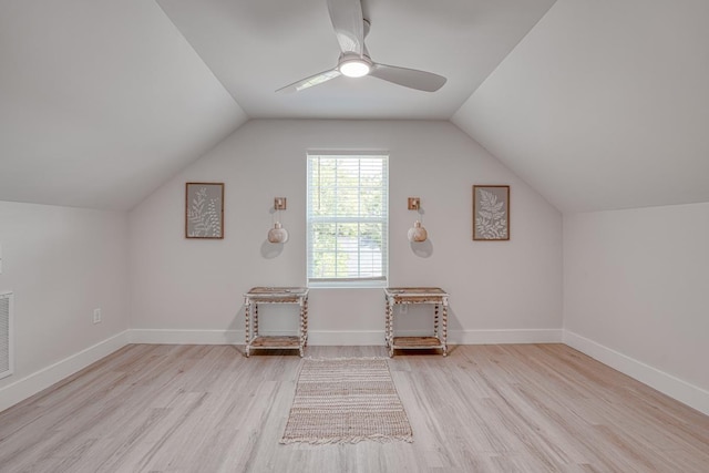 additional living space with light hardwood / wood-style flooring, vaulted ceiling, and ceiling fan