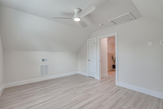 additional living space with ceiling fan, light hardwood / wood-style floors, and vaulted ceiling