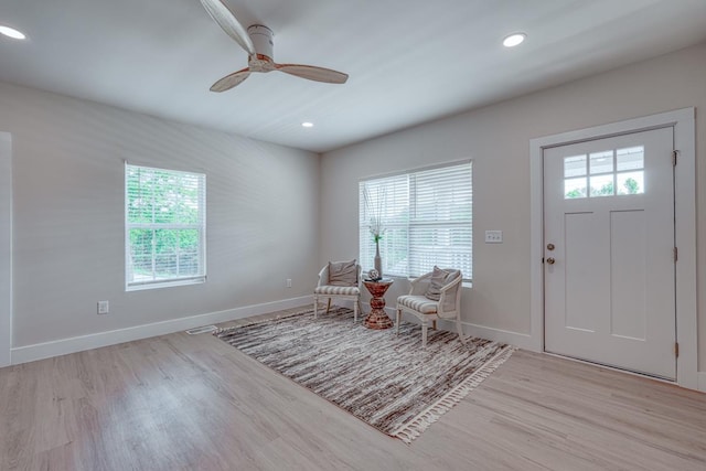 entrance foyer featuring ceiling fan, plenty of natural light, and light hardwood / wood-style floors