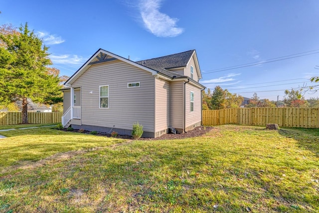 view of side of property with a lawn