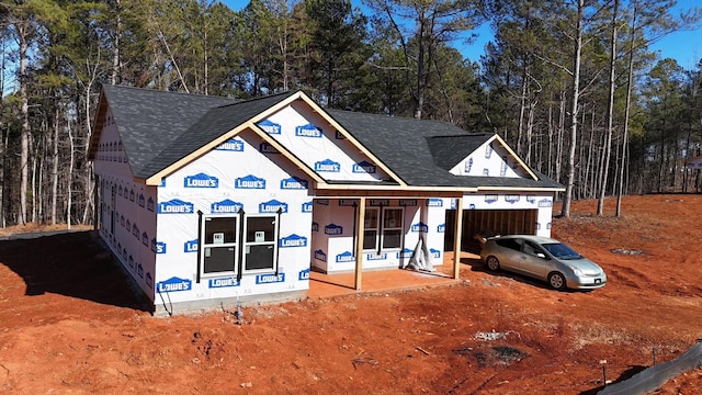 property in mid-construction with a garage and covered porch