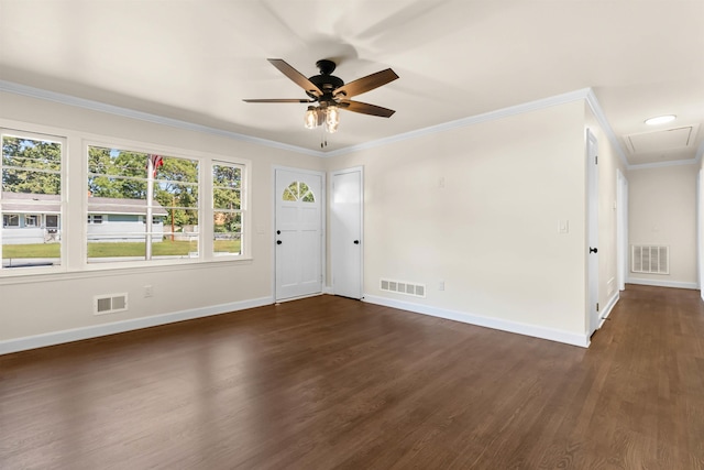 spare room featuring dark wood-type flooring, ornamental molding, and ceiling fan