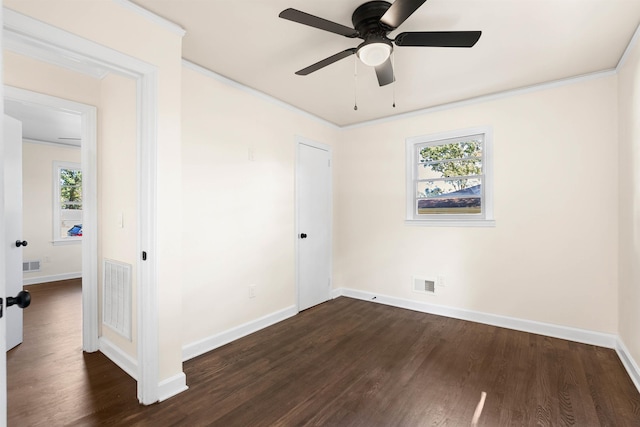 unfurnished bedroom with dark hardwood / wood-style flooring, crown molding, and ceiling fan