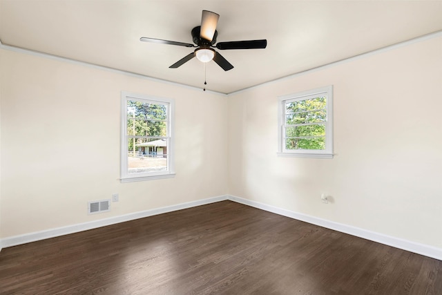 unfurnished room featuring ceiling fan, crown molding, a wealth of natural light, and dark hardwood / wood-style flooring