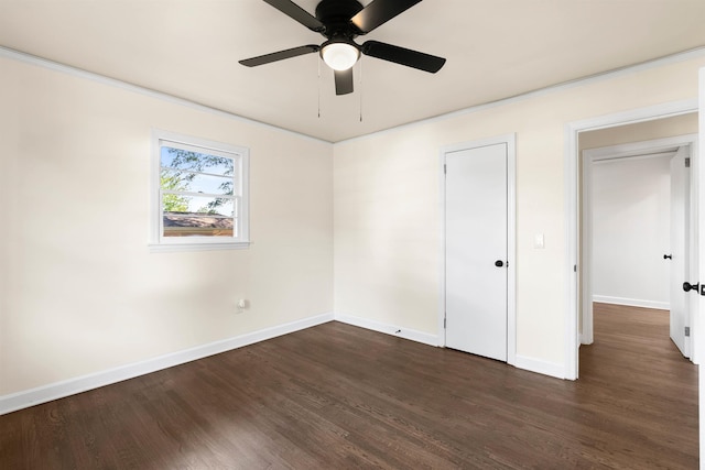 unfurnished bedroom featuring dark hardwood / wood-style flooring, crown molding, and ceiling fan