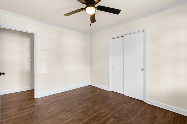 unfurnished bedroom with crown molding, ceiling fan, dark hardwood / wood-style flooring, and a closet