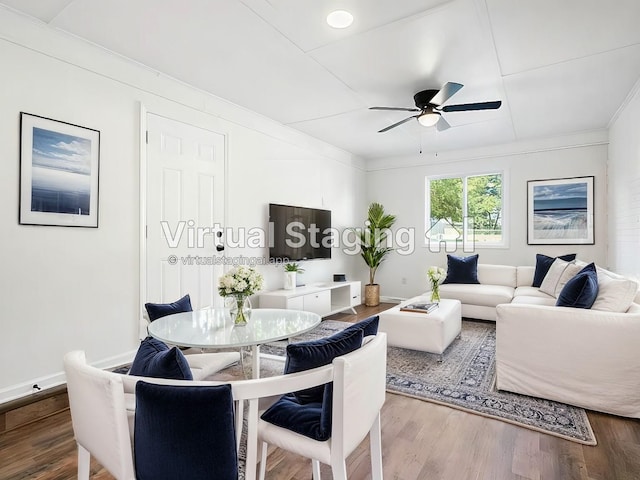 living room featuring hardwood / wood-style flooring, ceiling fan, and ornamental molding