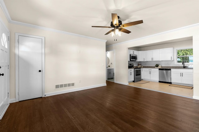 unfurnished living room featuring crown molding, ceiling fan, sink, and hardwood / wood-style floors