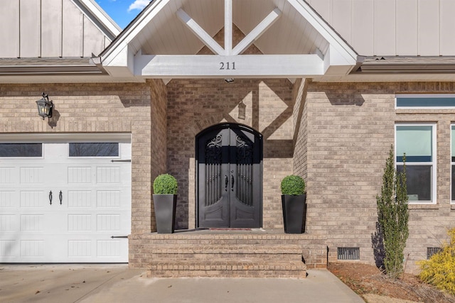 view of exterior entry with a garage